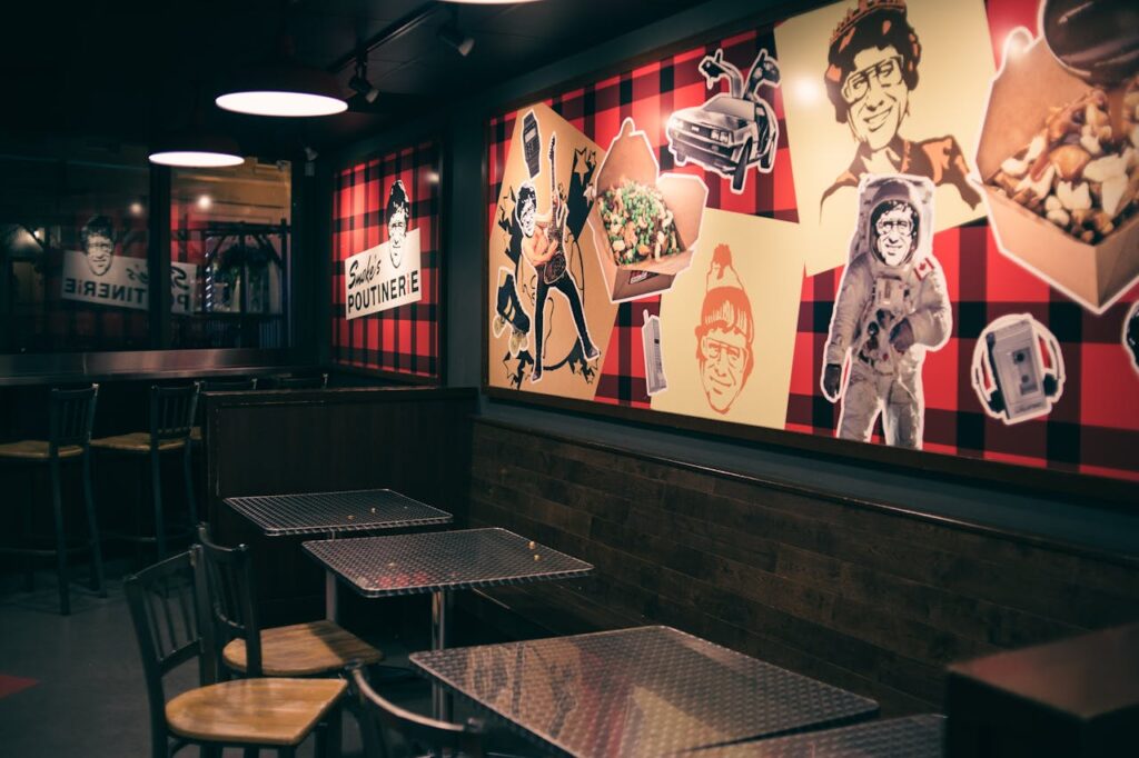 Charming restaurant interior with unique wall art and empty seating area, ideal for dining concepts.